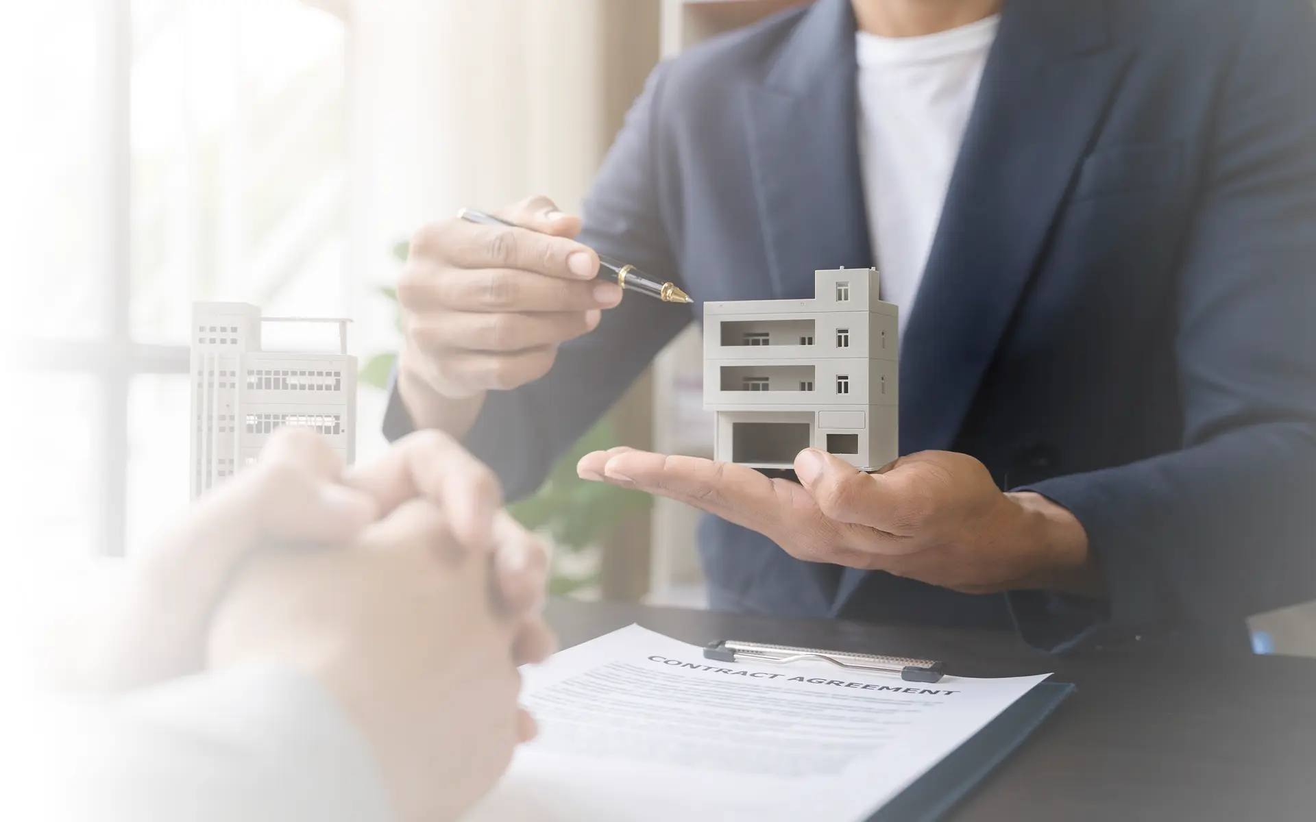 A man showing a small model of a building.
